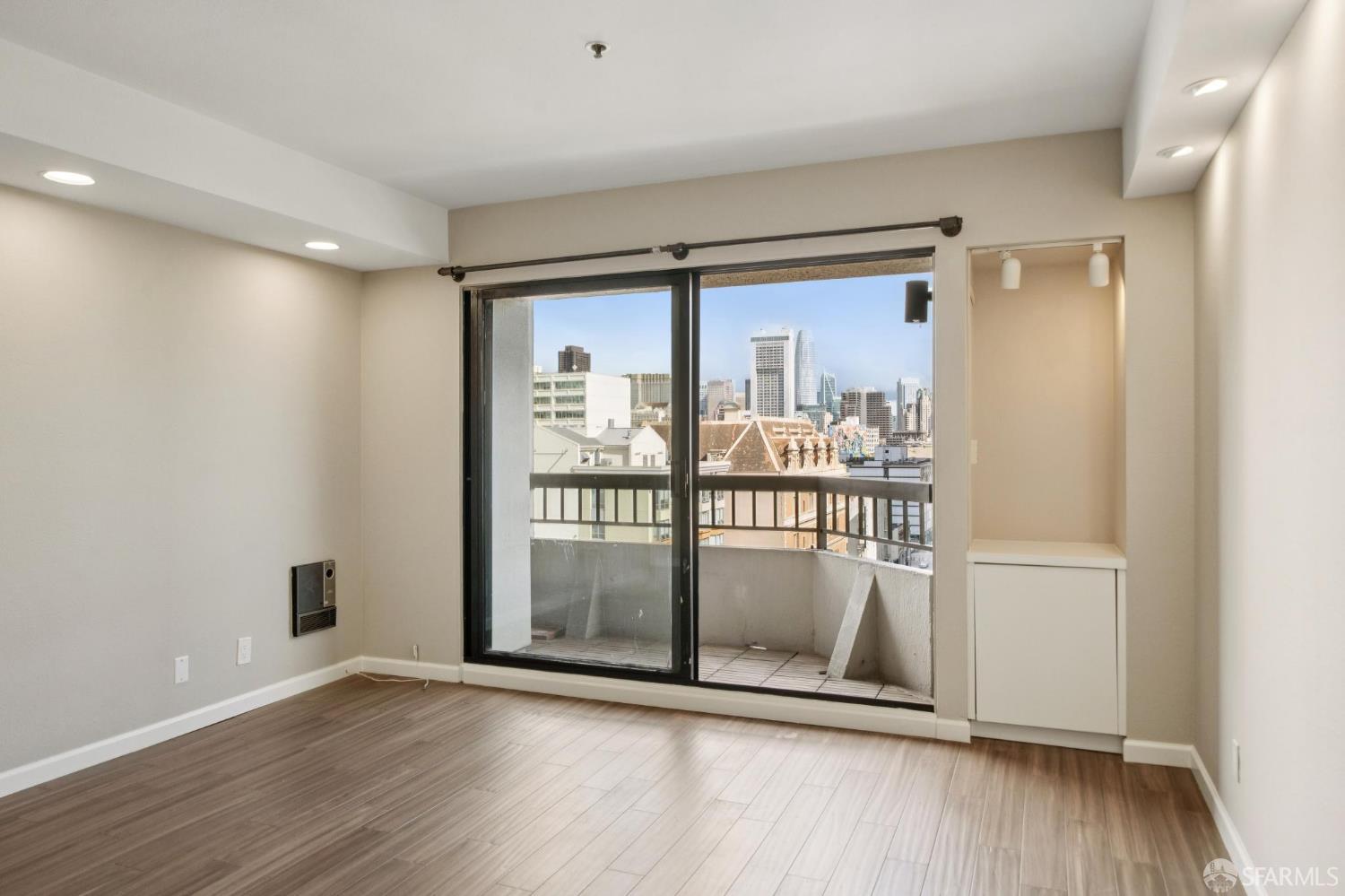 601 Van Ness Avenue, Unit 812 San Francisco, CA 94102 - Photo 15 of 33 an empty room with wooden floor and windows