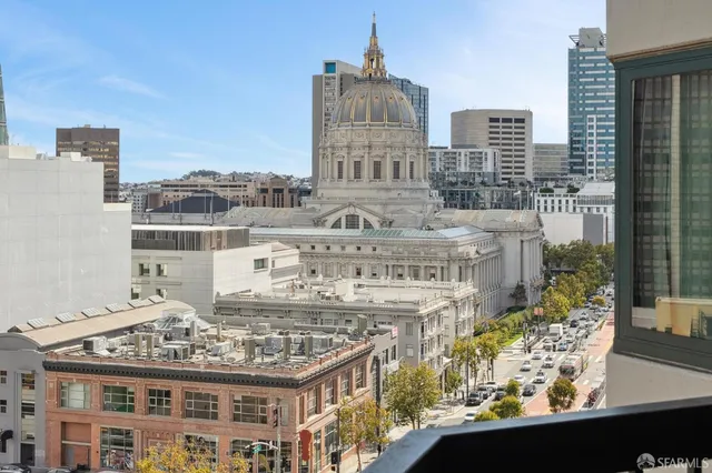a view of a large building with a table and chair