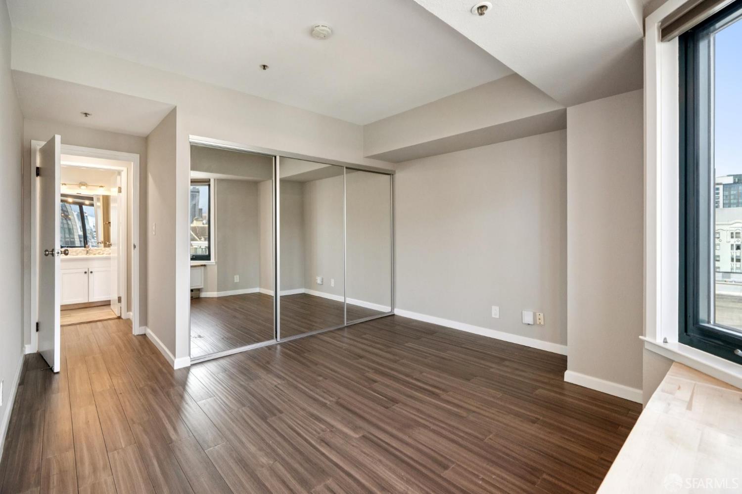 601 Van Ness Avenue, Unit 812 San Francisco, CA 94102 - Photo 22 of 33 wooden floor in an empty room with a window
