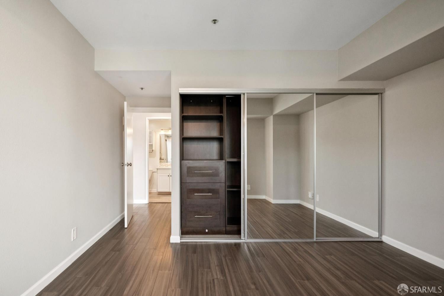 601 Van Ness Avenue, Unit 812 San Francisco, CA 94102 - Photo 23 of 33 an empty room with wooden floor closet and entryway