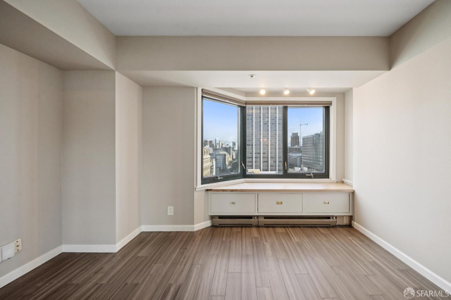 601 Van Ness Avenue, Unit 812 San Francisco, CA 94102 - Photo 24 of 33 a view of an empty room with wooden floor and a window