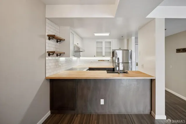 a view of kitchen with sink microwave and refrigerator