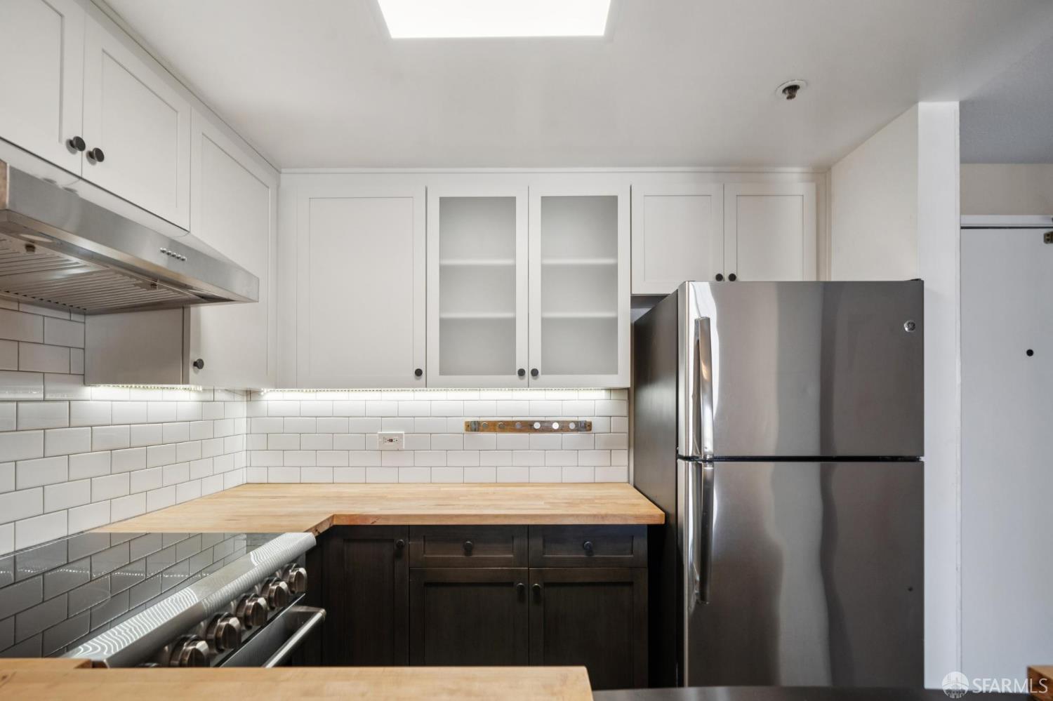 601 Van Ness Avenue, Unit 812 San Francisco, CA 94102 - Photo 5 of 33 a kitchen with a refrigerator and a sink