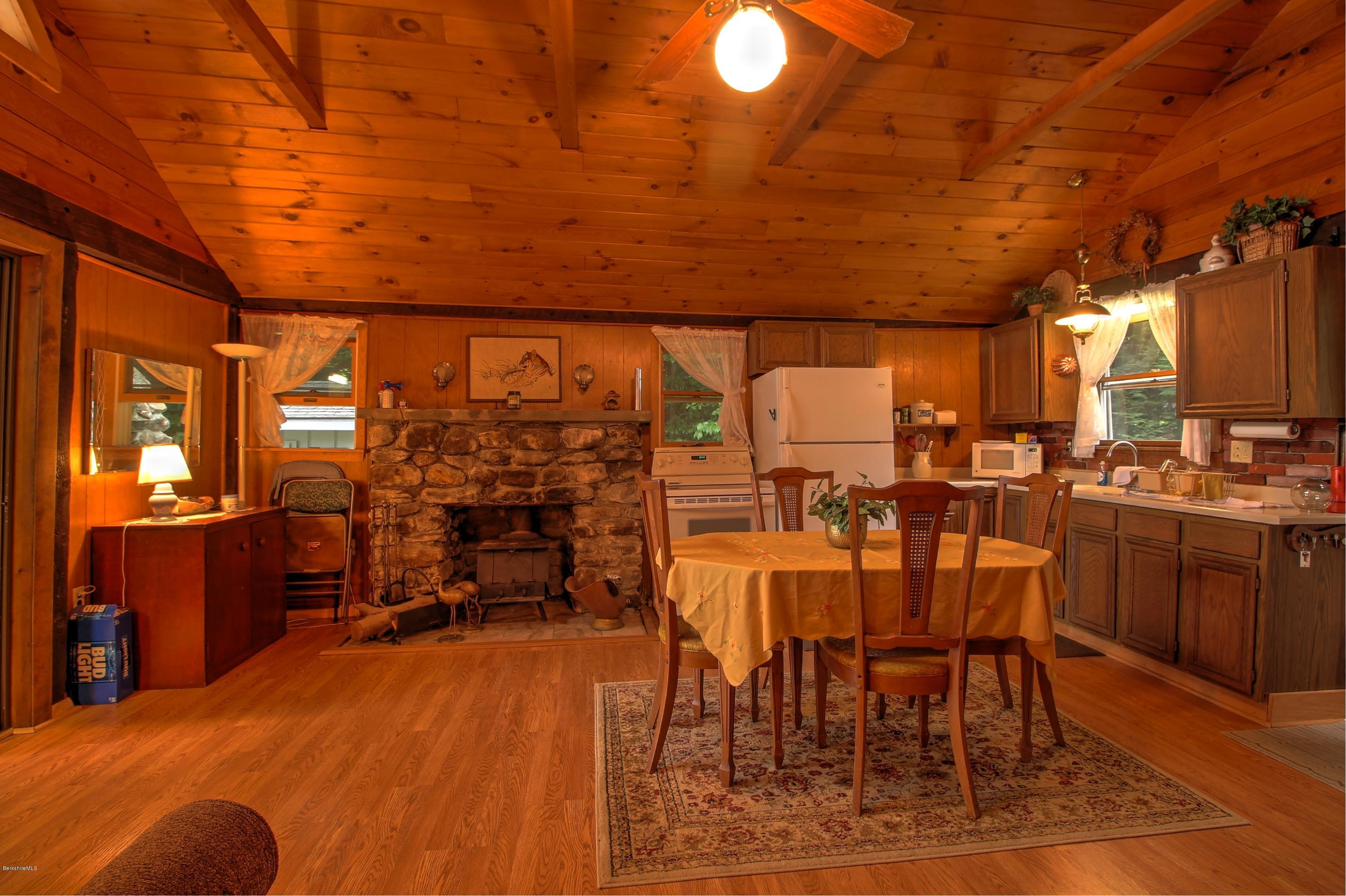59 Williams Road Becket, MA 01223 - Photo 5 of 18 a view of a dining room with furniture and chandelier