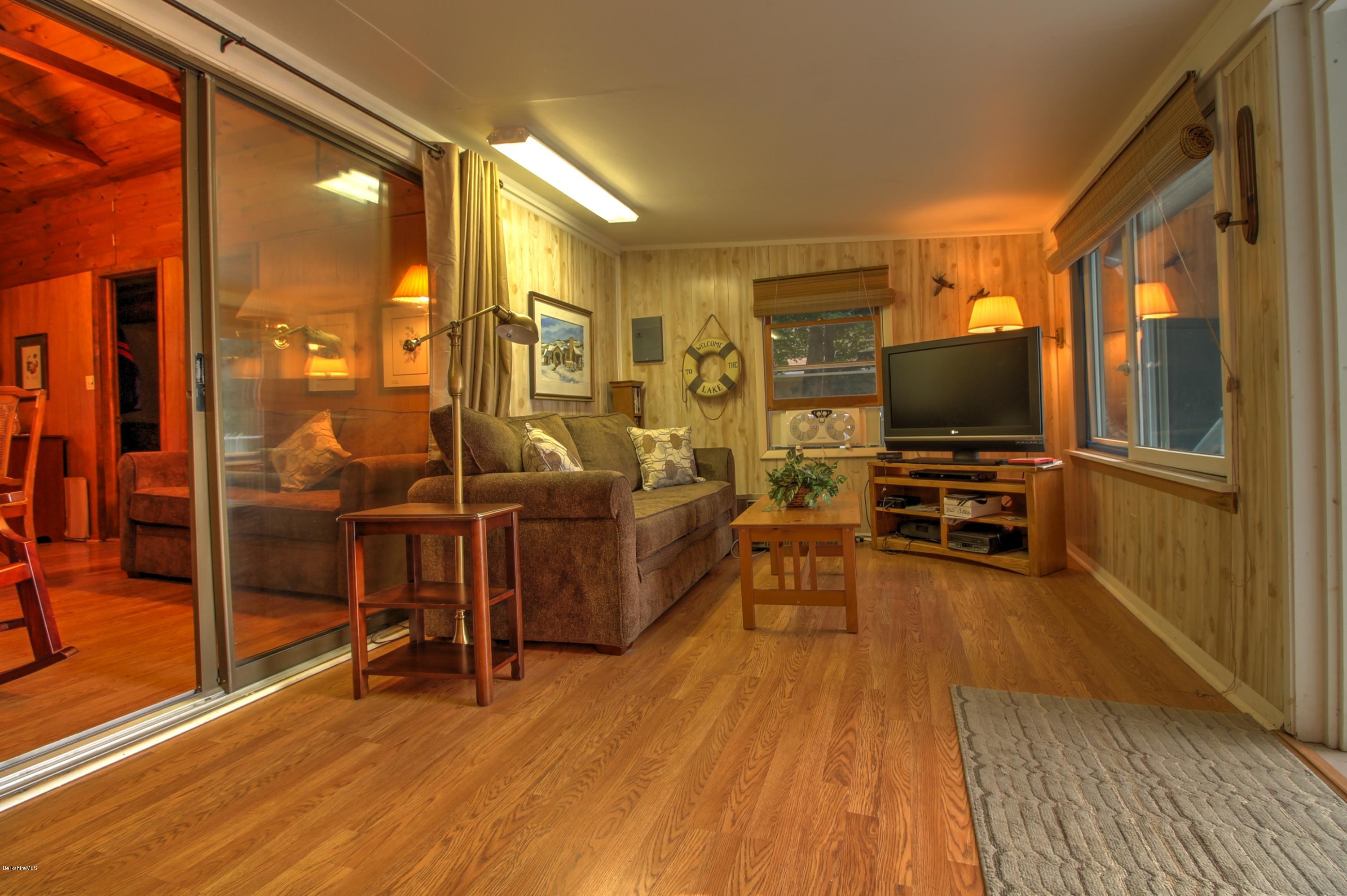 59 Williams Road Becket, MA 01223 - Photo 7 of 18 a view of a livingroom with furniture and a flat screen tv