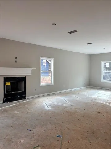a view of empty room with a fireplace