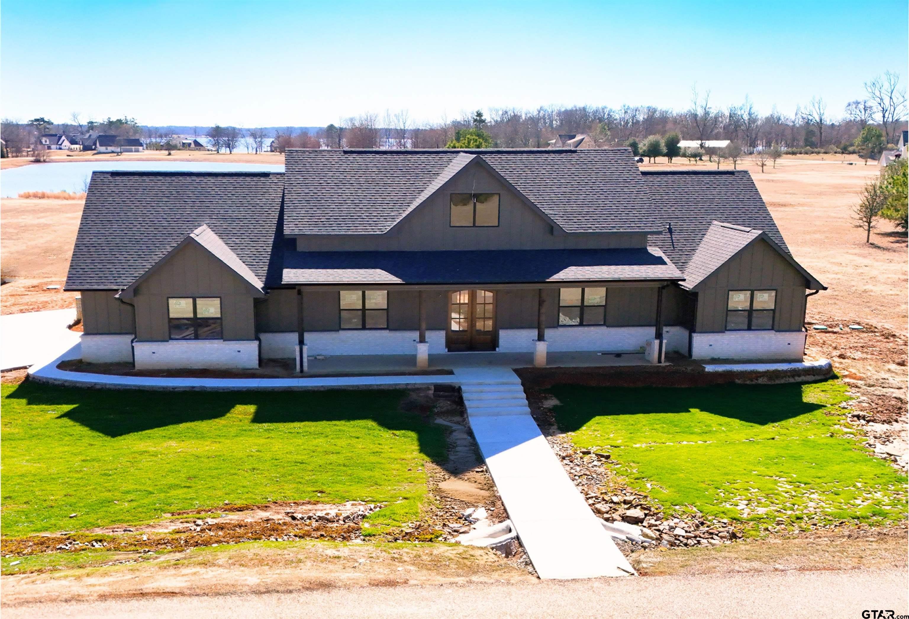 a view of a house with pool and chairs