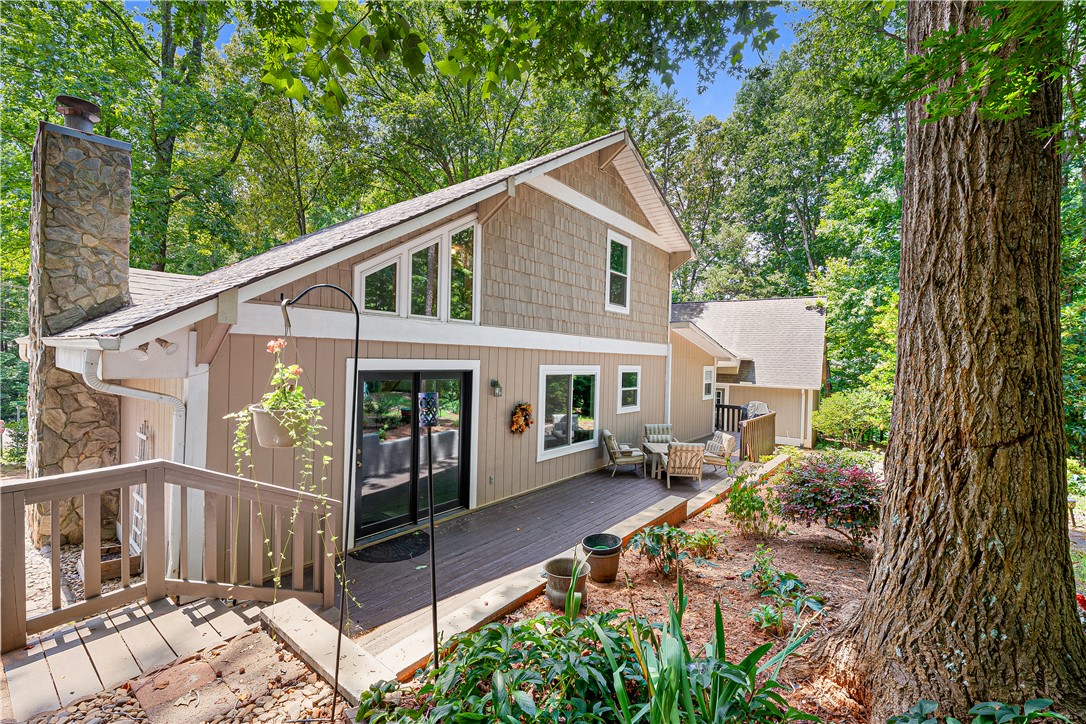 139 Tulip Lane Westminster, SC 29693 - Photo 4 of 37 An inviting wood deck extends from this multi-level residence, framed by mature trees and vibrant landscaping.