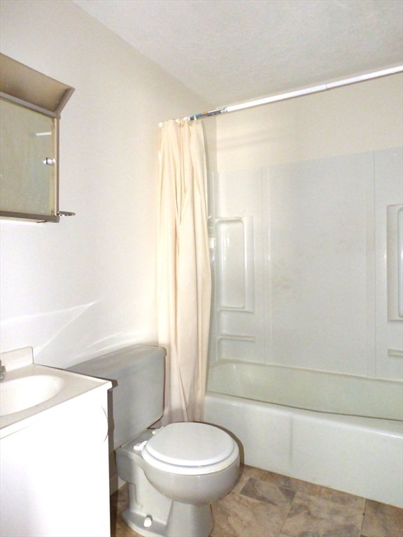 26-28 Daniel Street Springfield, MA 01151 - Photo 11 of 15 a bathroom with a shower a toilet and a sink