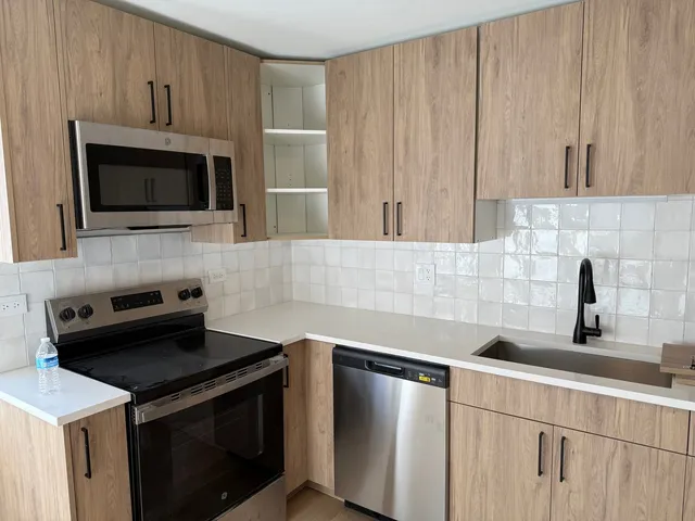 a kitchen with a sink stove and microwave