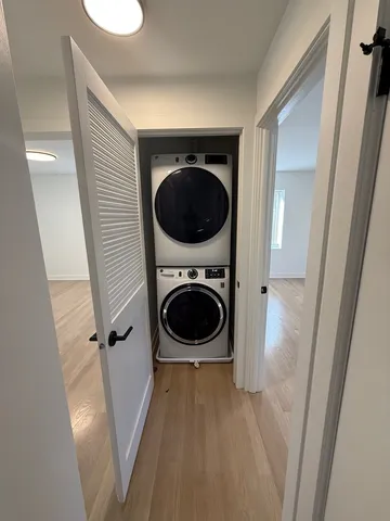 a view of a hallway with washer and dryer