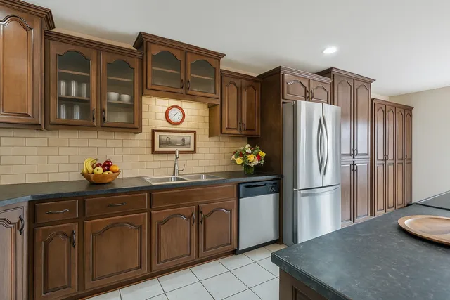 a bedroom with a large bed a flat tv screen and dresser
