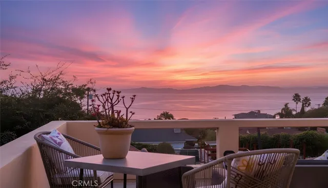 a view of a balcony with table and chairs
