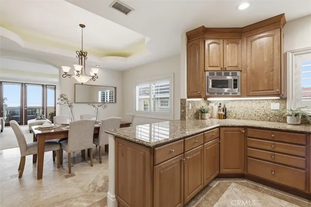 a kitchen with center island table and chairs in it