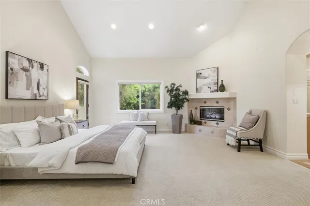 a spacious bedroom with a bed and a couch