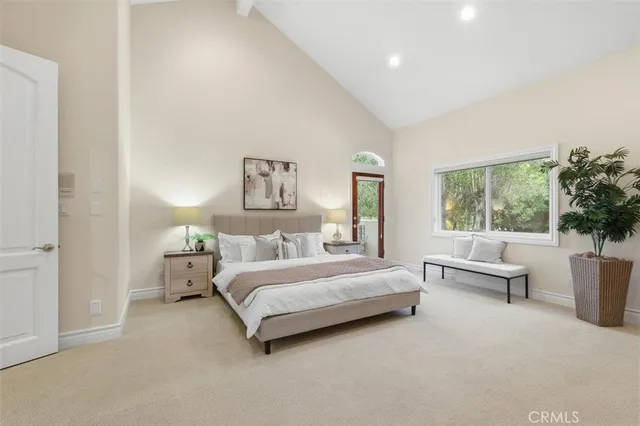 a spacious bedroom with a bed and a couch