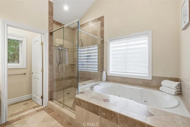 a bathroom with a tub a sink and a shower