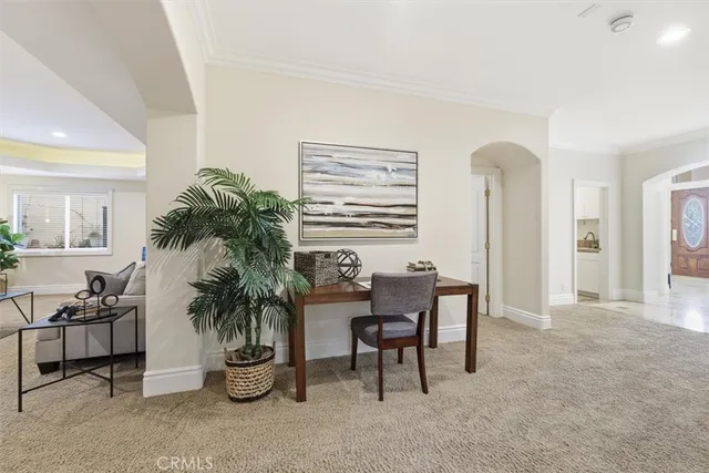 a dining room with furniture and a potted plant
