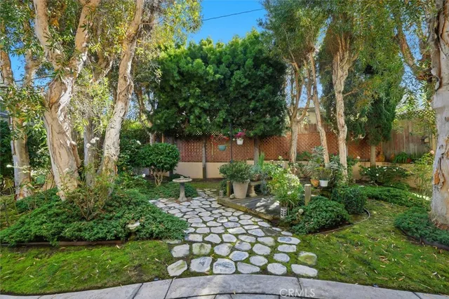 a view of a house with a yard and sitting area