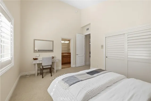 a bedroom with a bed and a table in it