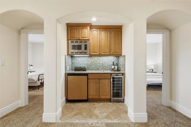 a en suite bathroom with a granite countertop sink and mirror