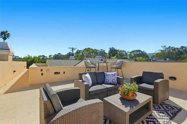a view of a balcony with furniture and a potted plant