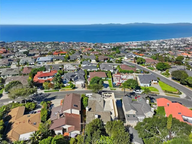an aerial view of a houses with a lake