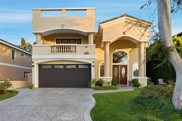 a front view of a house with a garden