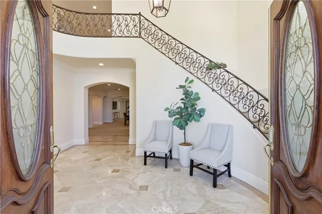 a view of a hallway with a potted plant and stairs