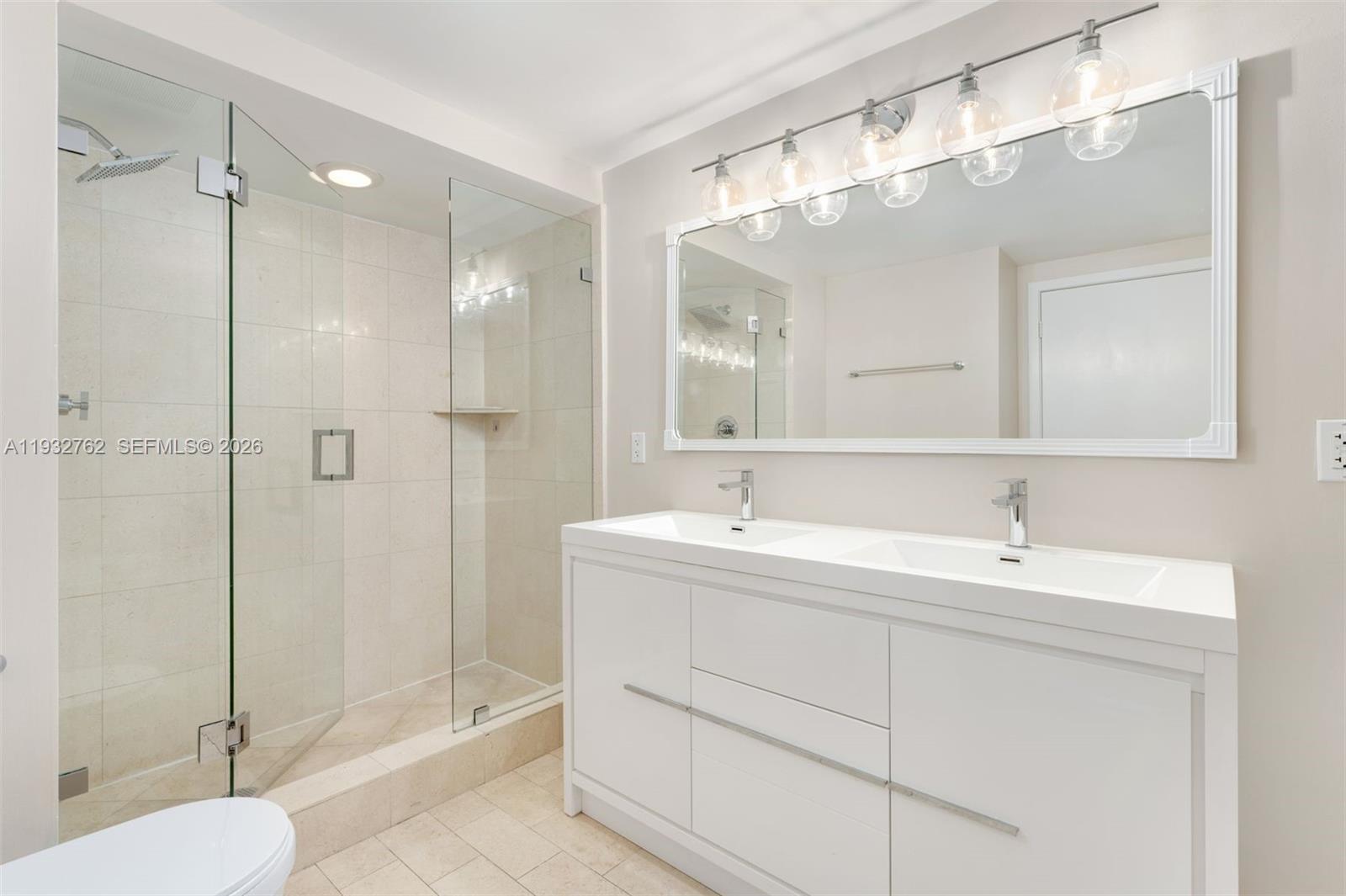 1111 Southwest 1st Avenue, Unit 721N Miami, FL 33130 - Photo 13 of 41 a bathroom with a double vanity sink mirror and shower