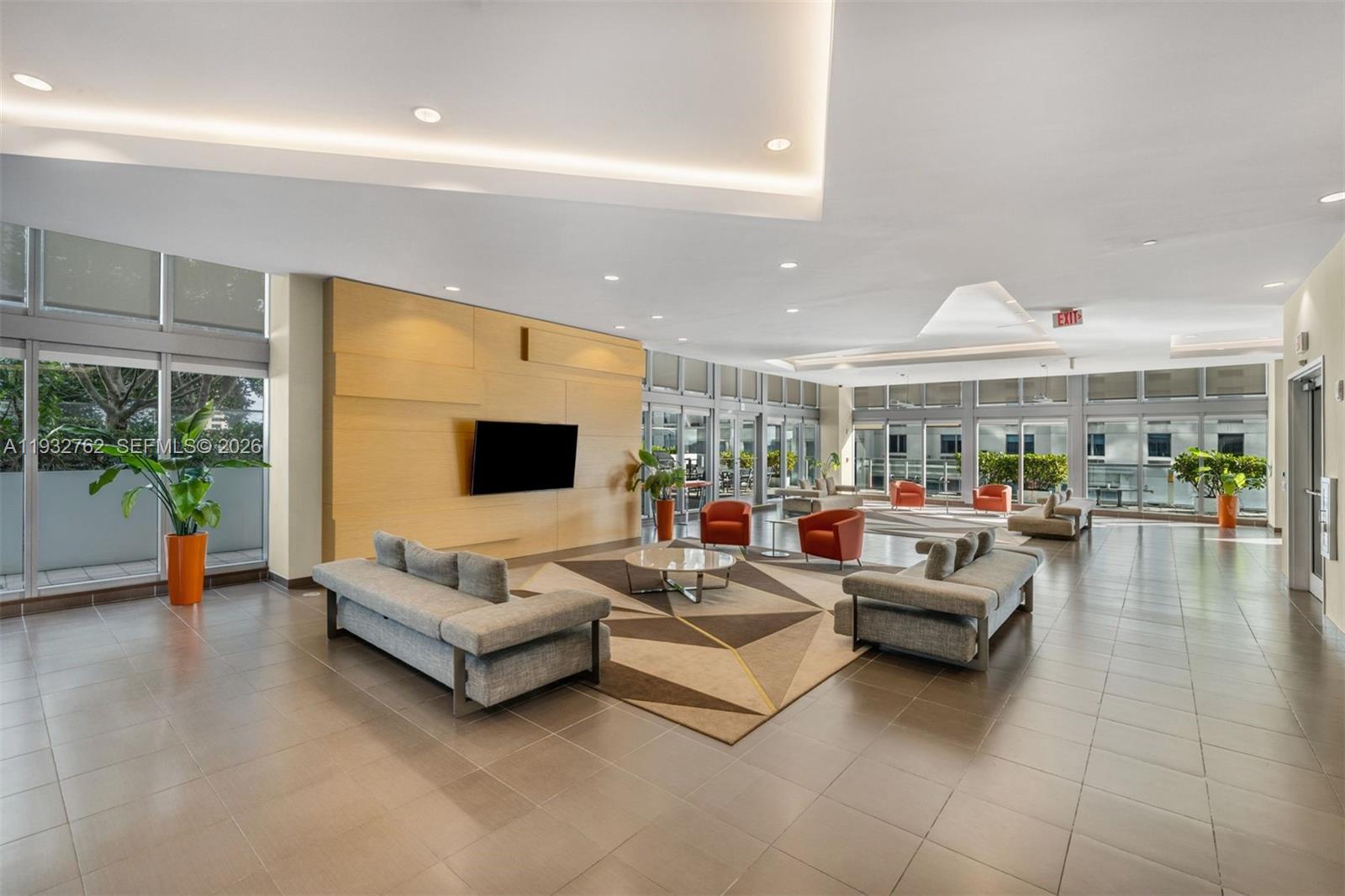 1111 Southwest 1st Avenue, Unit 721N Miami, FL 33130 - Photo 30 of 41 a living room with furniture and a flat screen tv