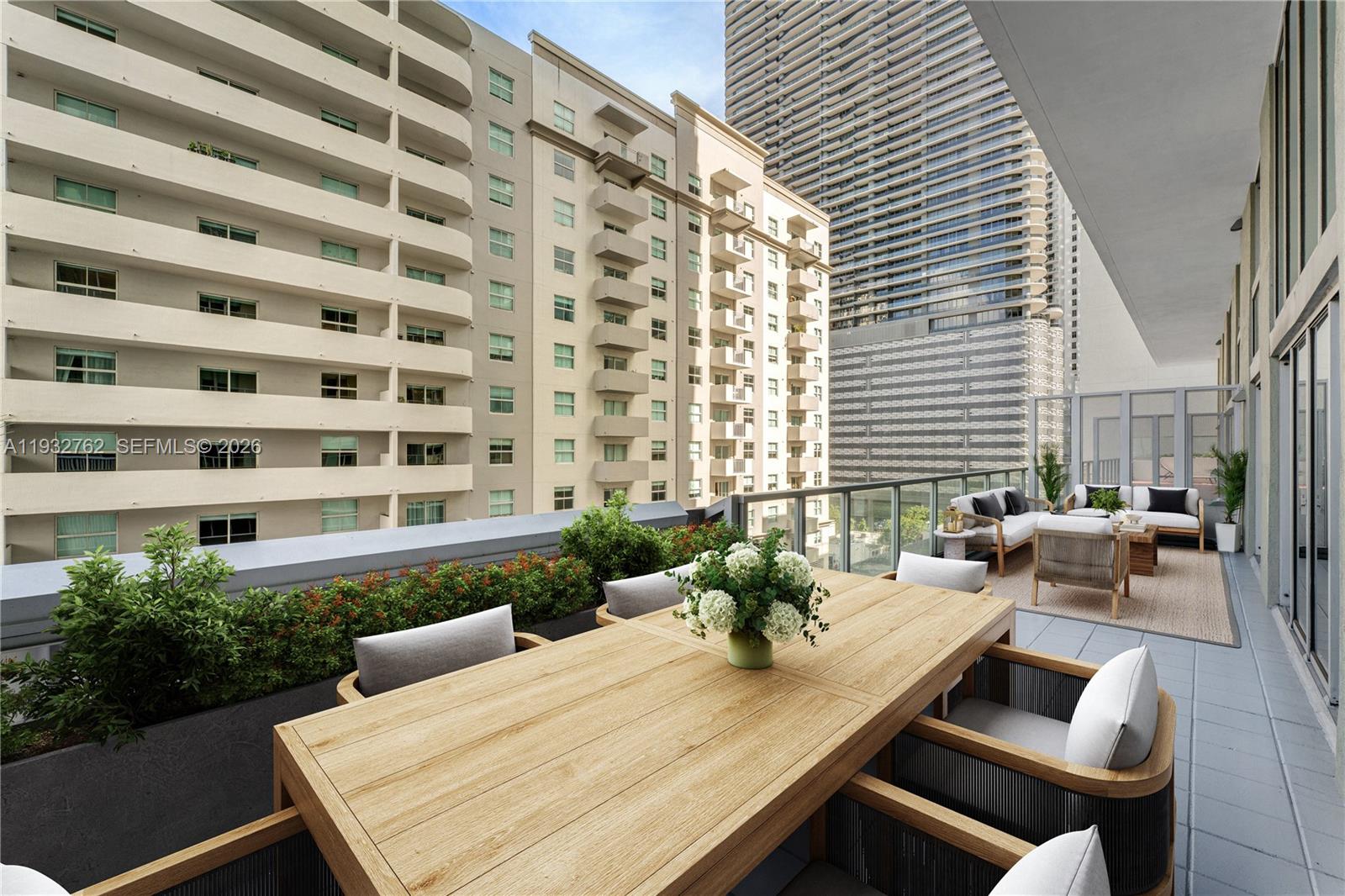 1111 Southwest 1st Avenue, Unit 721N Miami, FL 33130 - Photo 6 of 41 a view of a patio with dining table and chairs with wooden floor and plants