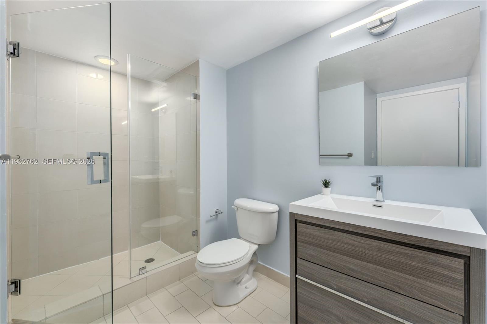 1111 Southwest 1st Avenue, Unit 721N Miami, FL 33130 - Photo 10 of 41 a bathroom with a sink a toilet and shower