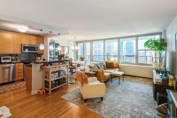 a living room with furniture flat screen tv and a large window