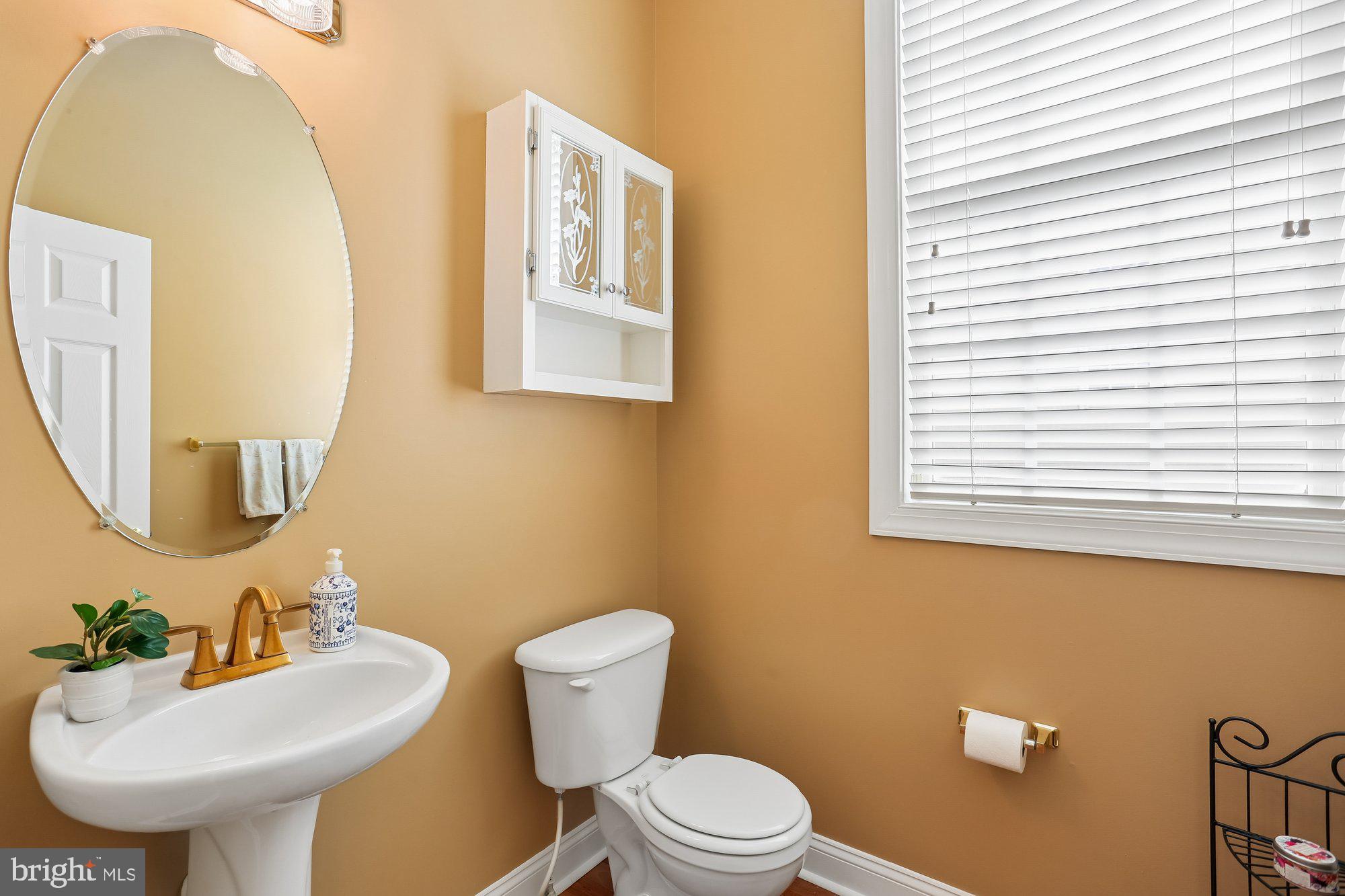 945 Main Street Gaithersburg, MD 20878 - Photo 22 of 57 a bathroom with a toilet sink and mirror