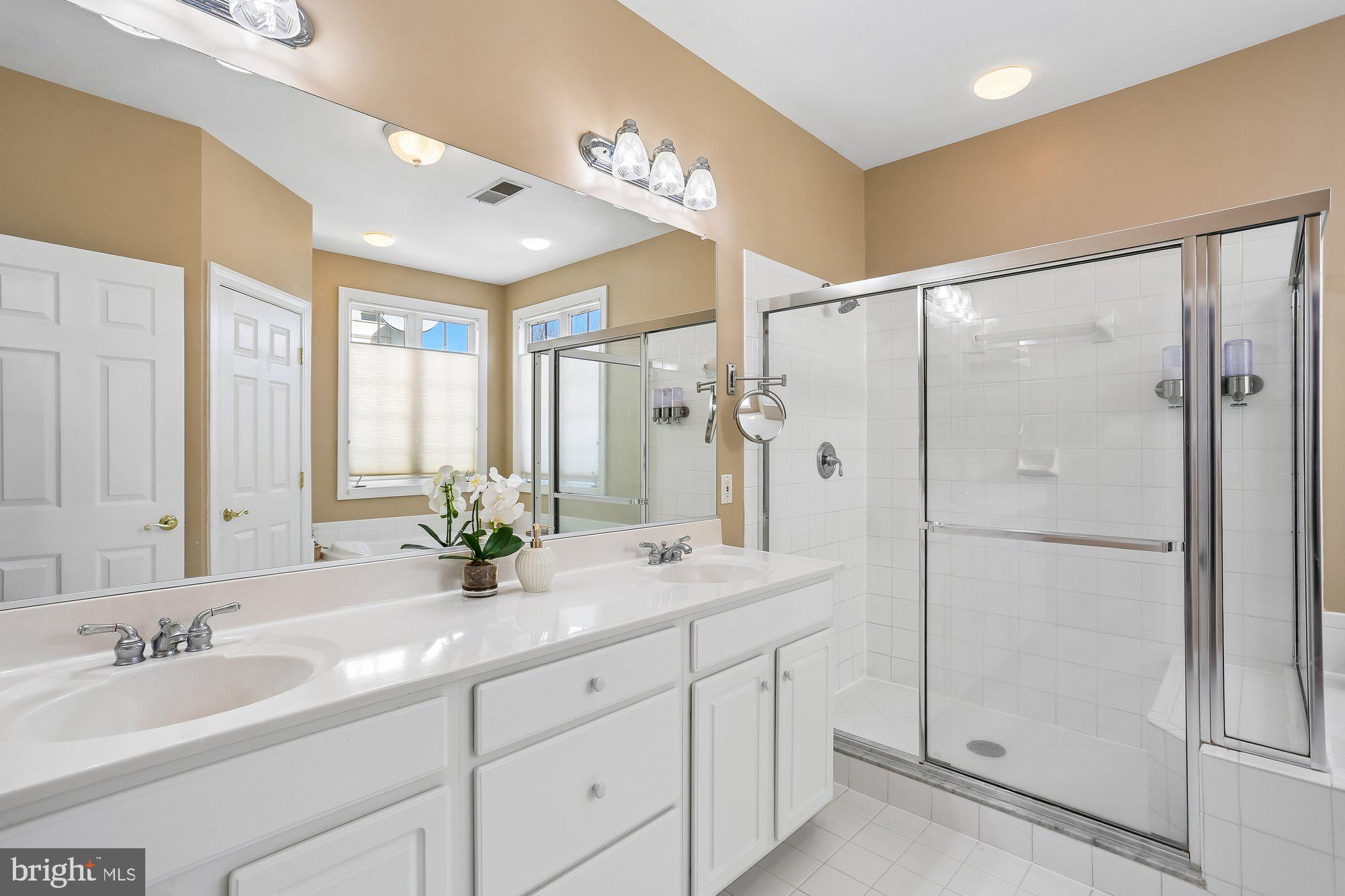 945 Main Street Gaithersburg, MD 20878 - Photo 27 of 57 a spacious bathroom with a shower sink and mirror