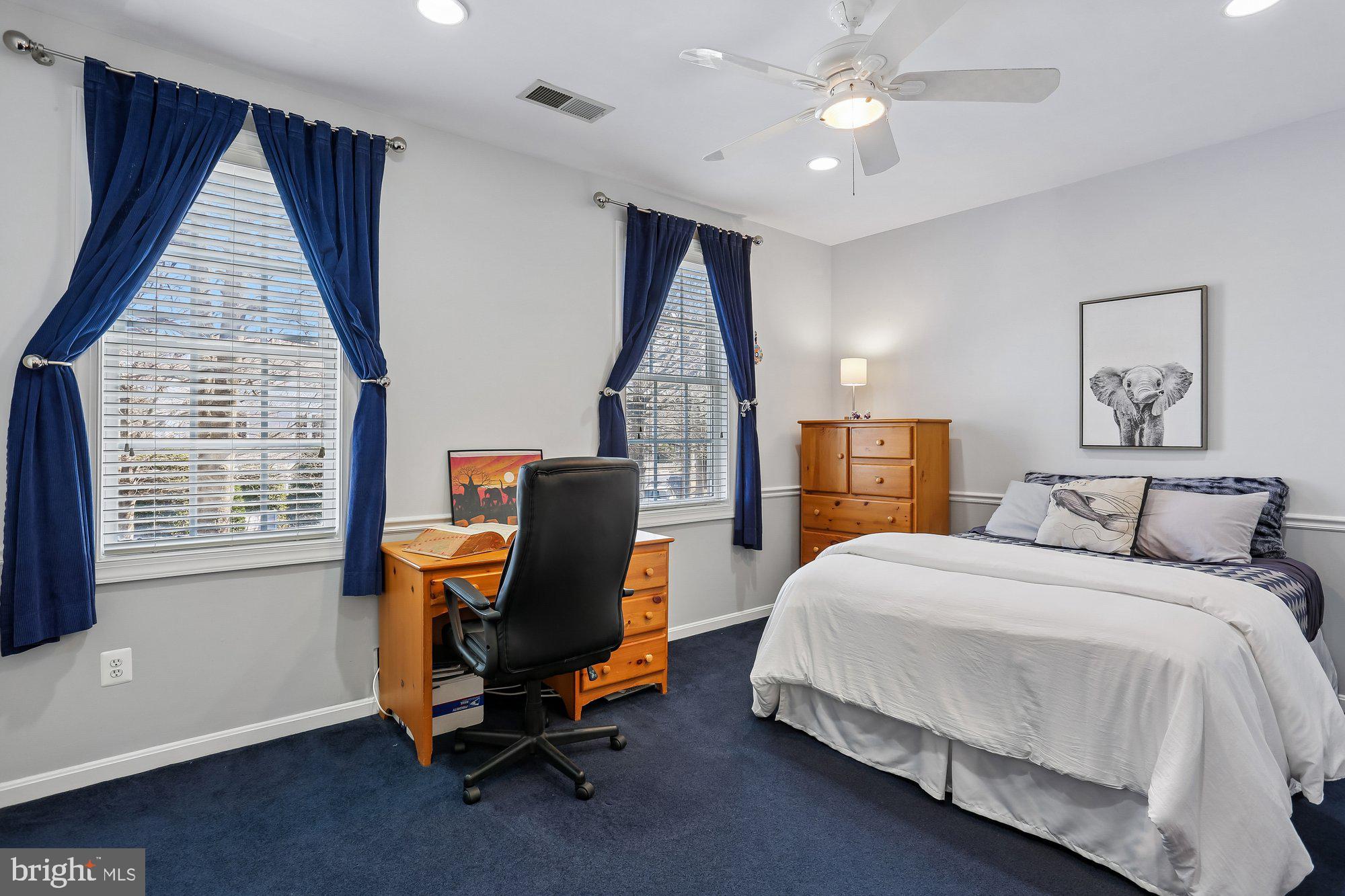 945 Main Street Gaithersburg, MD 20878 - Photo 30 of 57 a bedroom with a bed a desk and chair