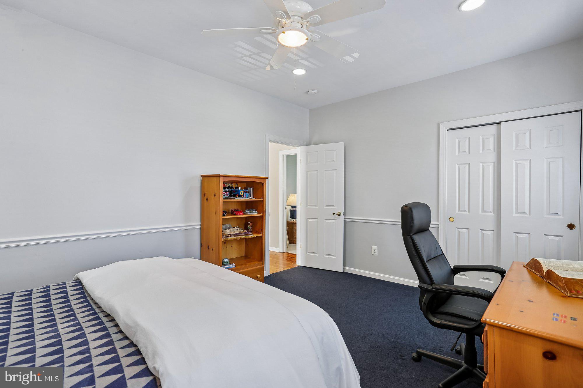 945 Main Street Gaithersburg, MD 20878 - Photo 31 of 57 a bedroom with a bed a desk and chair