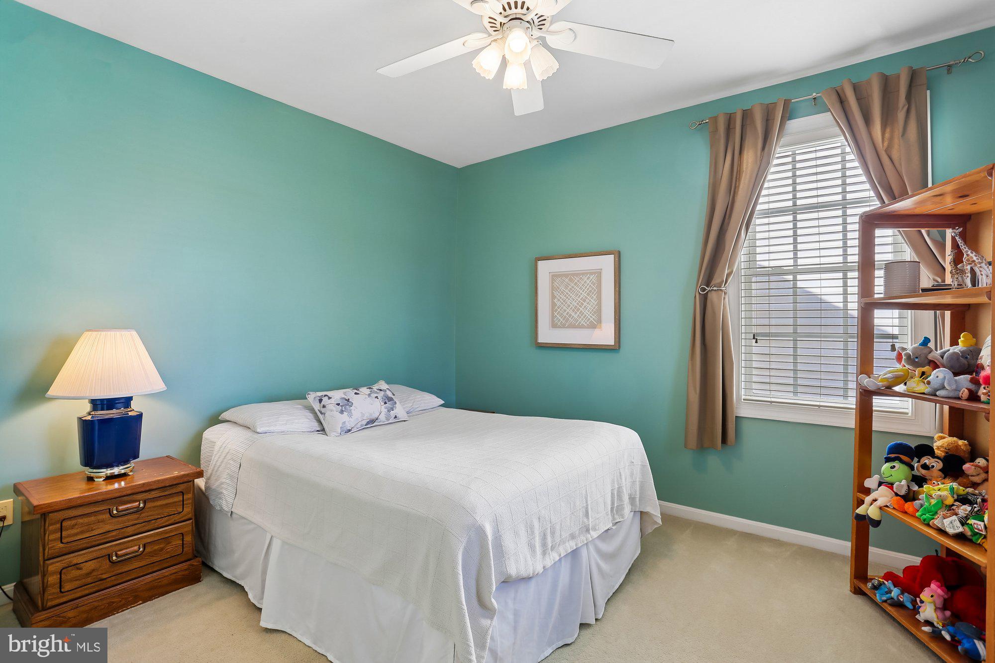 945 Main Street Gaithersburg, MD 20878 - Photo 32 of 57 a bedroom with a bed and a chandelier