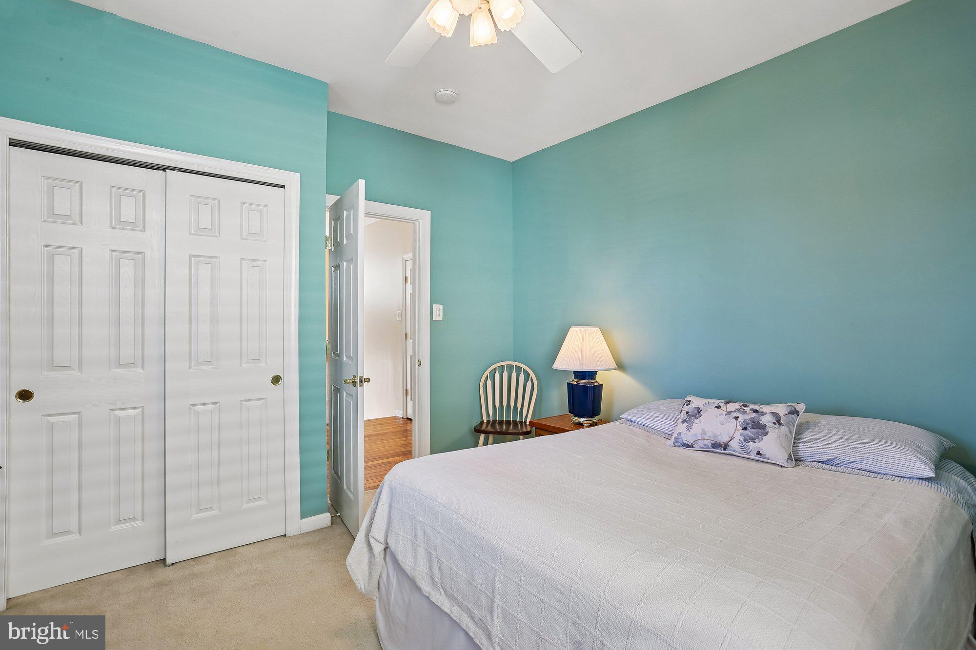 945 Main Street Gaithersburg, MD 20878 - Photo 33 of 57 a bedroom with a bed and a chandelier