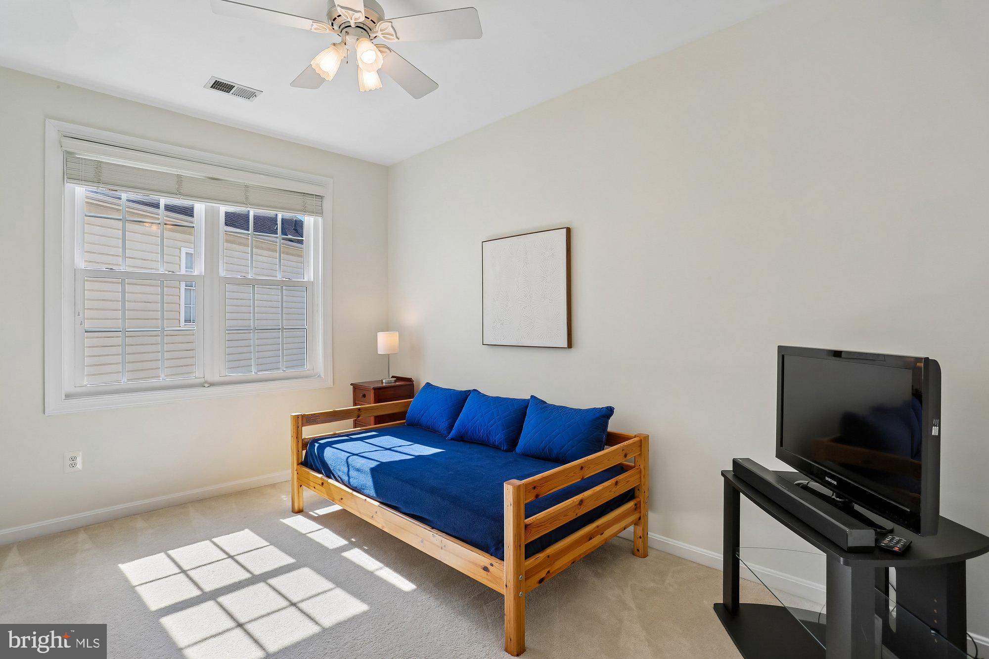 945 Main Street Gaithersburg, MD 20878 - Photo 34 of 57 a living room with furniture a flat screen tv and a window