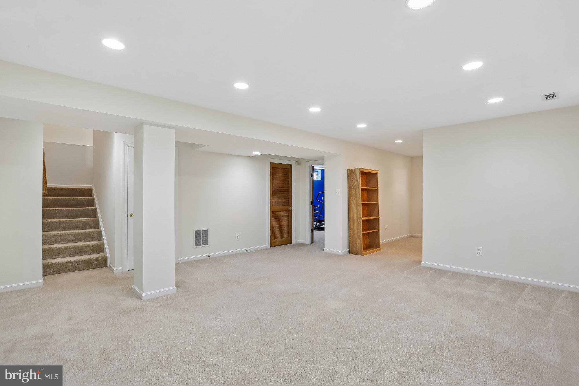 945 Main Street Gaithersburg, MD 20878 - Photo 37 of 57 an empty room with wooden floor and stairs