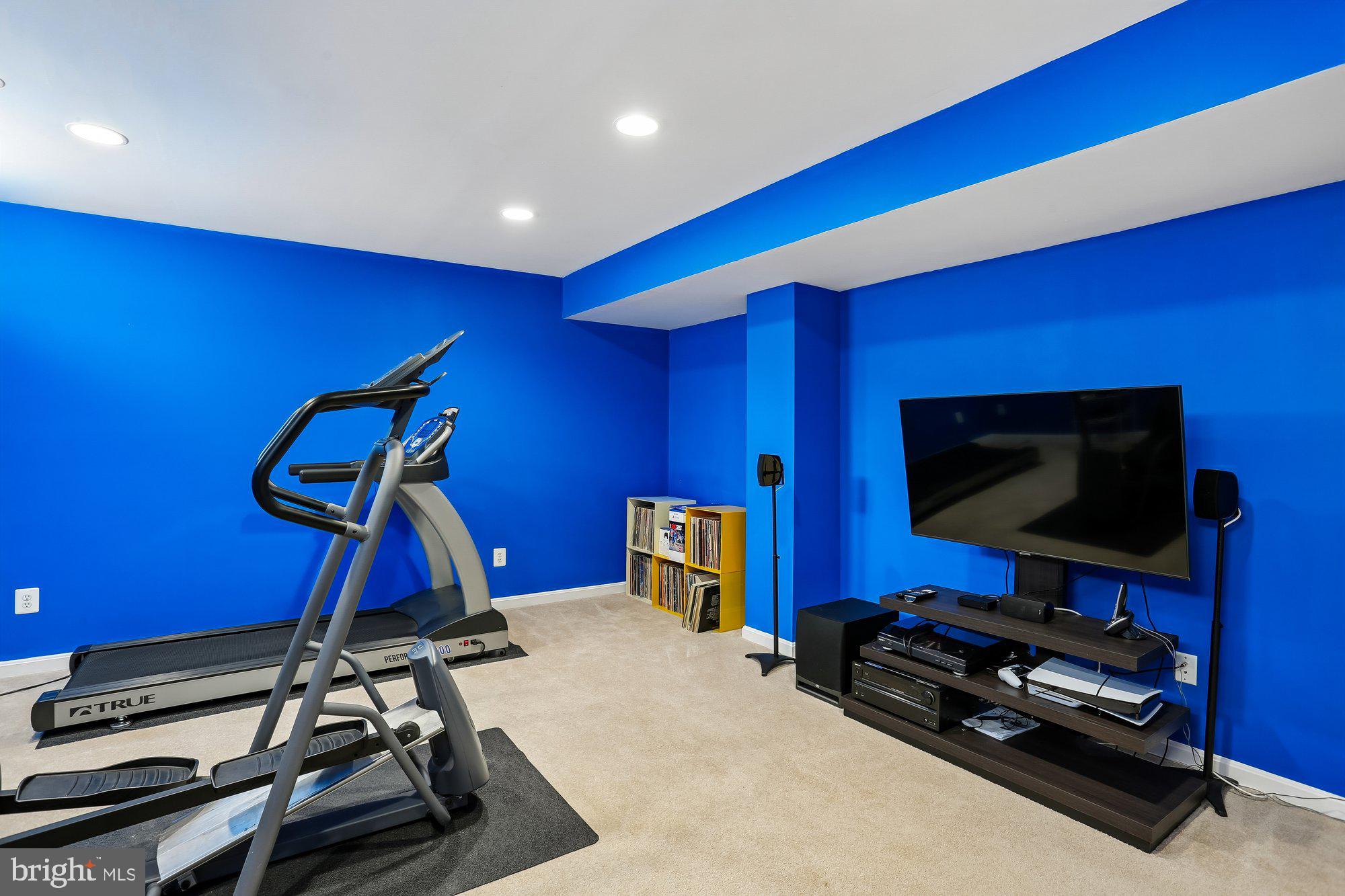 945 Main Street Gaithersburg, MD 20878 - Photo 41 of 57 a room with gym equipment and a flat screen tv