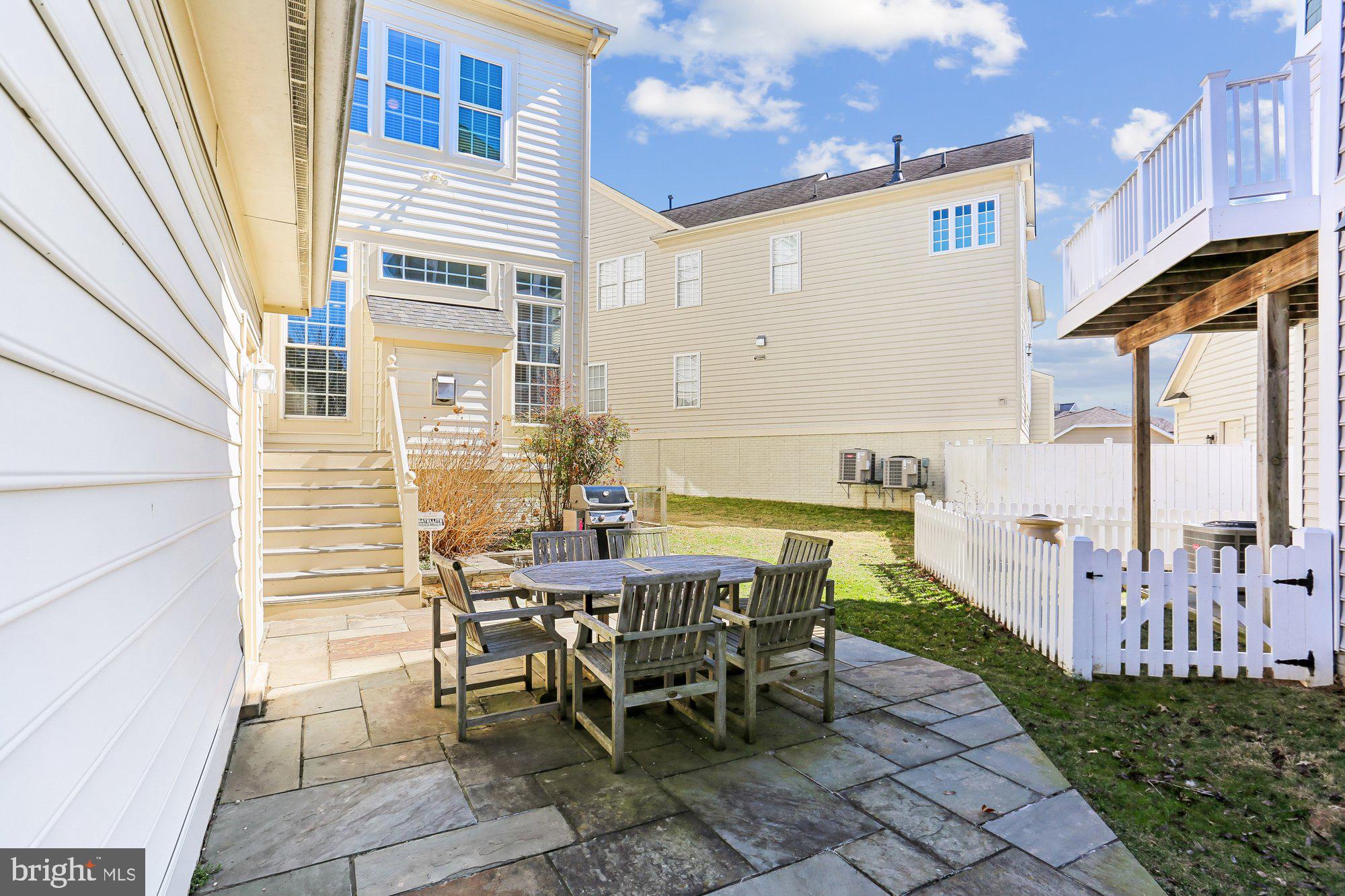 945 Main Street Gaithersburg, MD 20878 - Photo 45 of 57 a view of a patio with table and chairs and potted plants