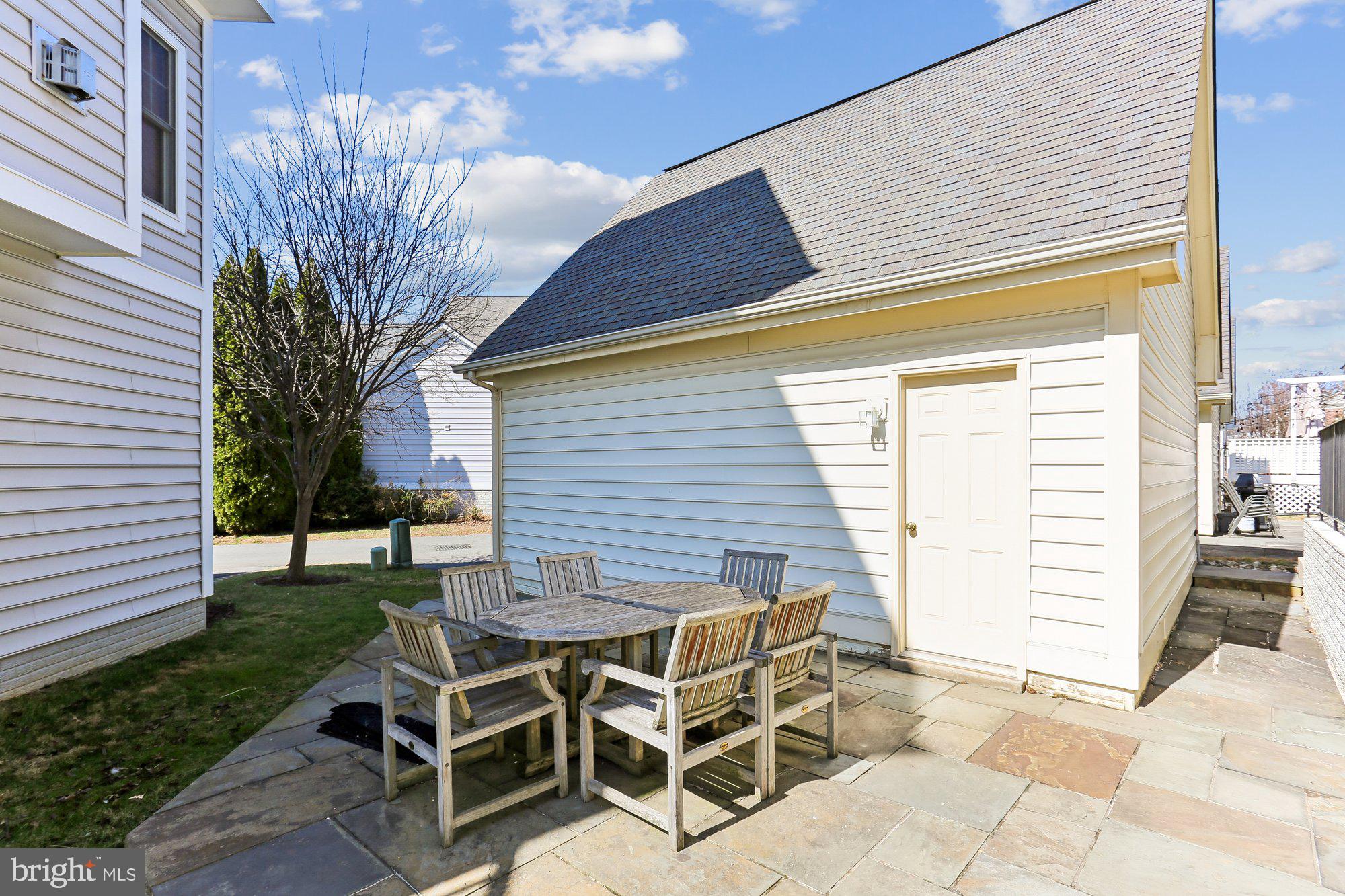945 Main Street Gaithersburg, MD 20878 - Photo 46 of 57 a view of a patio with table and chairs with wooden fence and plants