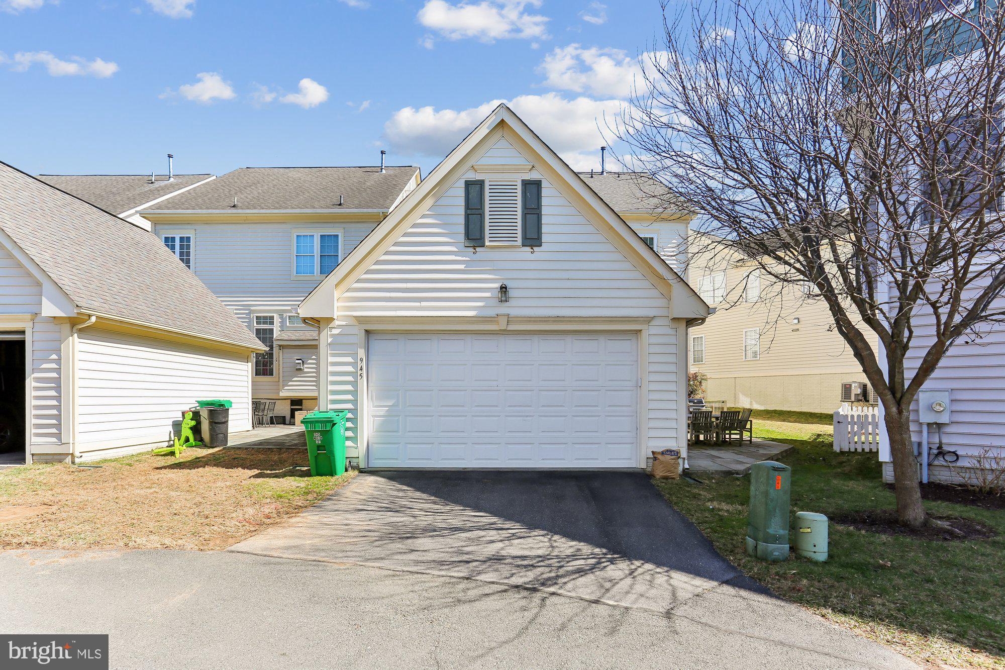 945 Main Street Gaithersburg, MD 20878 - Photo 47 of 57 a front view of a house with a yard and garage