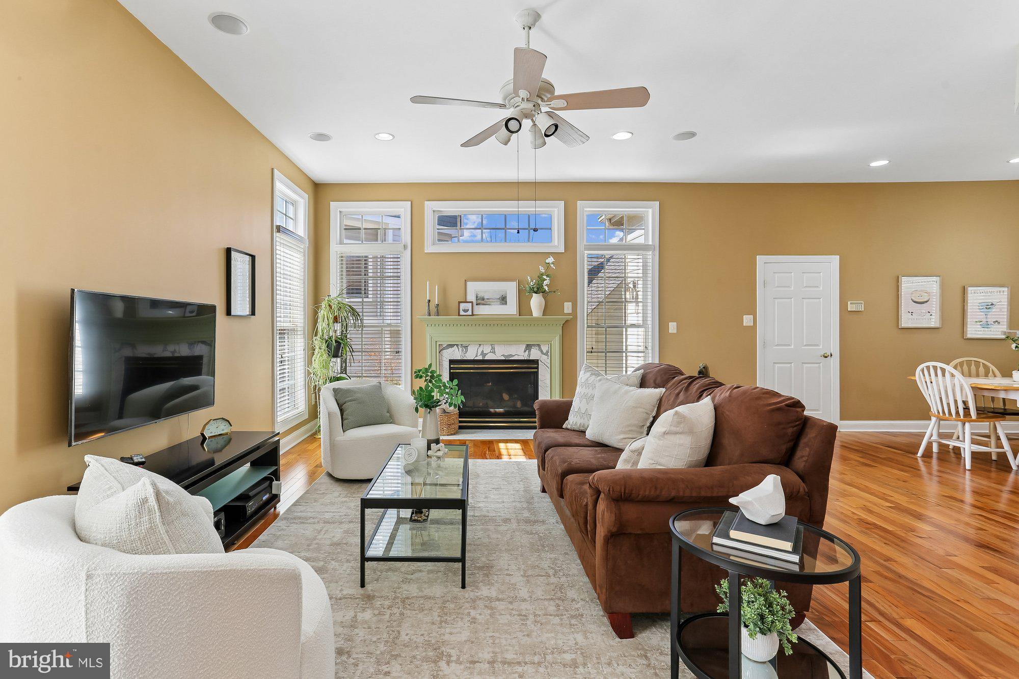 945 Main Street Gaithersburg, MD 20878 - Photo 6 of 57 a living room with furniture a fireplace and a flat screen tv