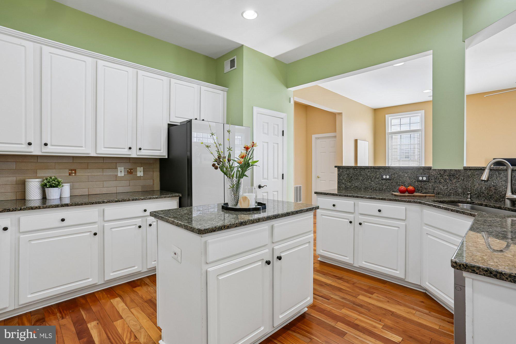 945 Main Street Gaithersburg, MD 20878 - Photo 10 of 57 a kitchen with granite countertop white cabinets and white appliances