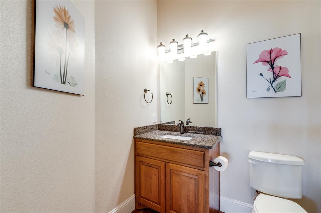 643 County Road 2255 Telephone, TX 75488 - Photo 17 of 40 Half bathroom with vanity and toilet