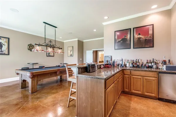 a room with pool table and wooden floor